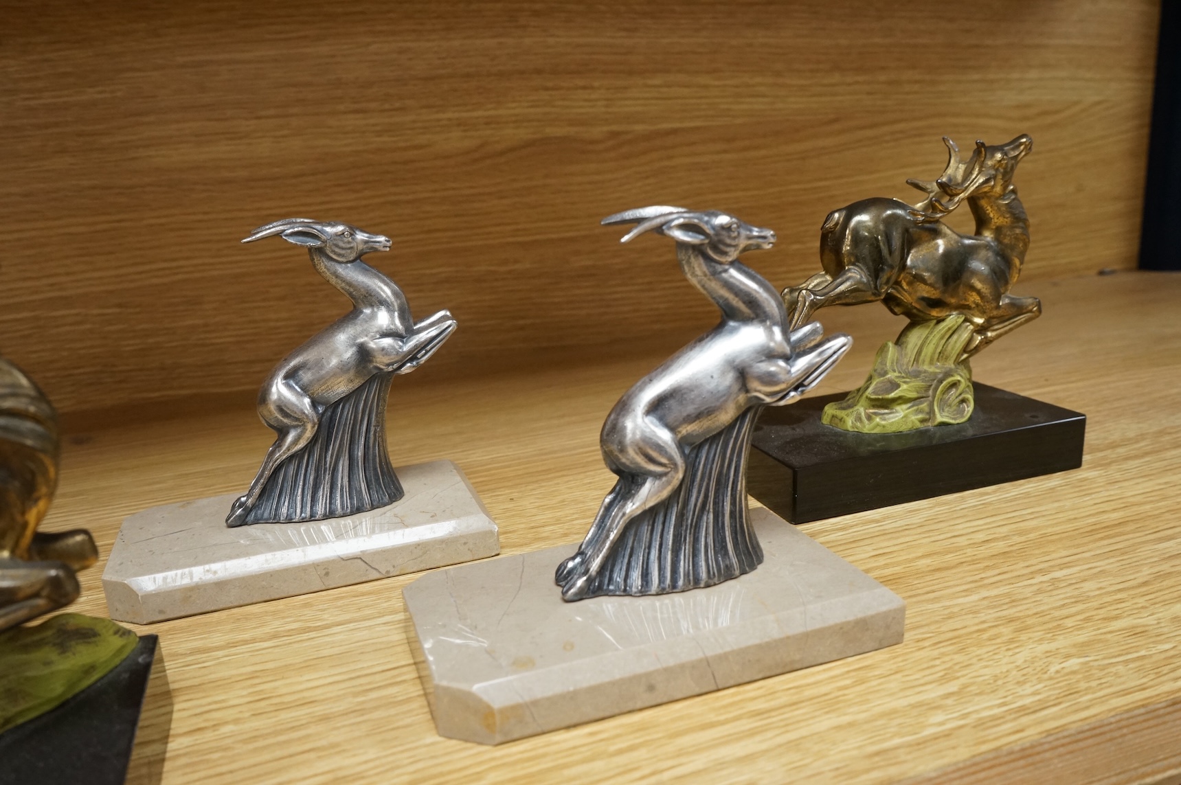 Two pairs of Art Deco bookends in the form of leaping animals, largest 14cm wide